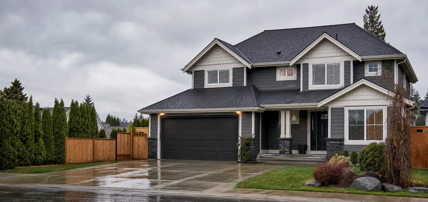 Rain-wet Cloverdale home with a dark architectural-shingle roof